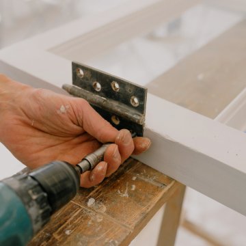 screwing nails into a bracket